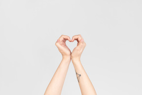 Female hands making a heart