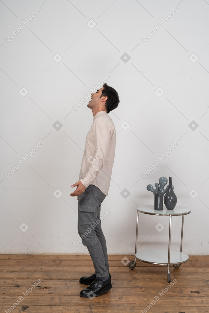 Side view of a man in casual clothes shouting