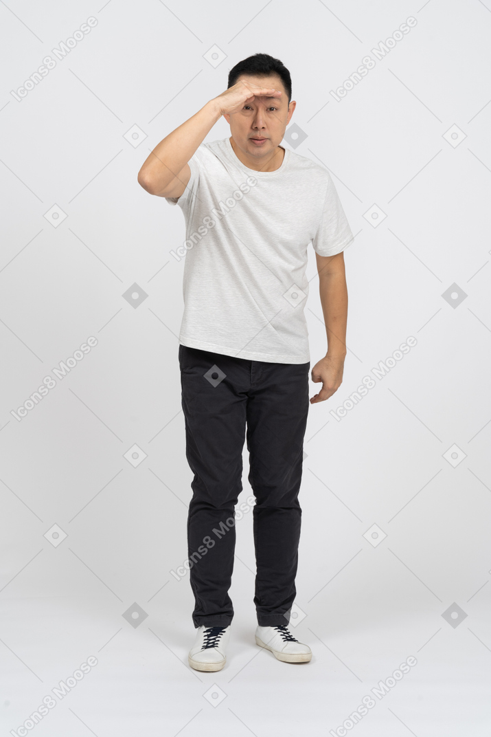 Front view of a man in casual clothes looking for someone