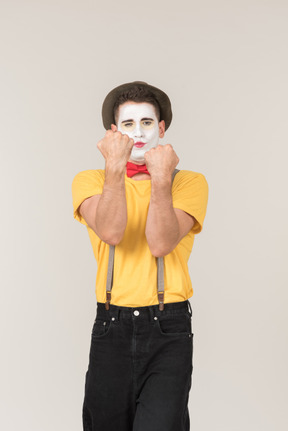 Male clown holding his fists up