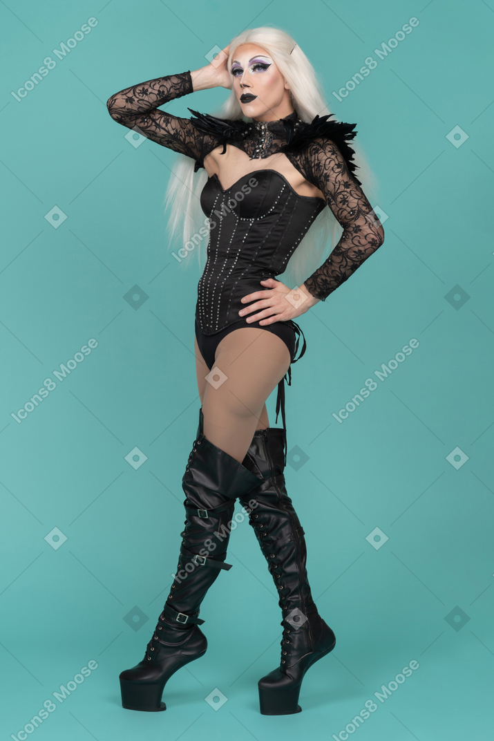 Transvestite keeping hand on head and on hips
