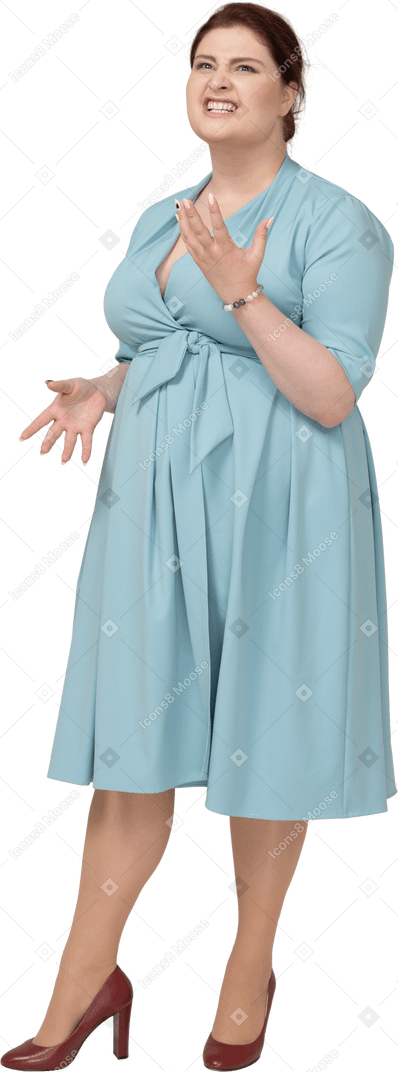 Front view of a woman in blue gesturing and making faces