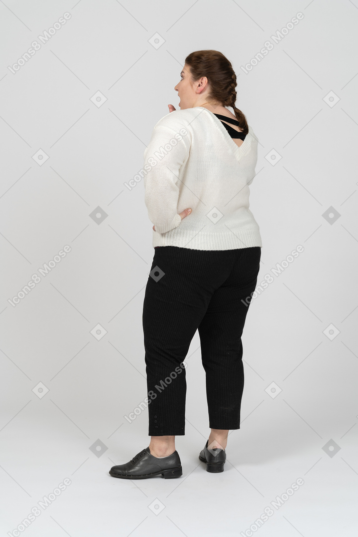 Plump woman in casual clothes standing