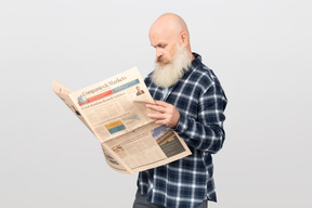 Bearded man reading a newspaper