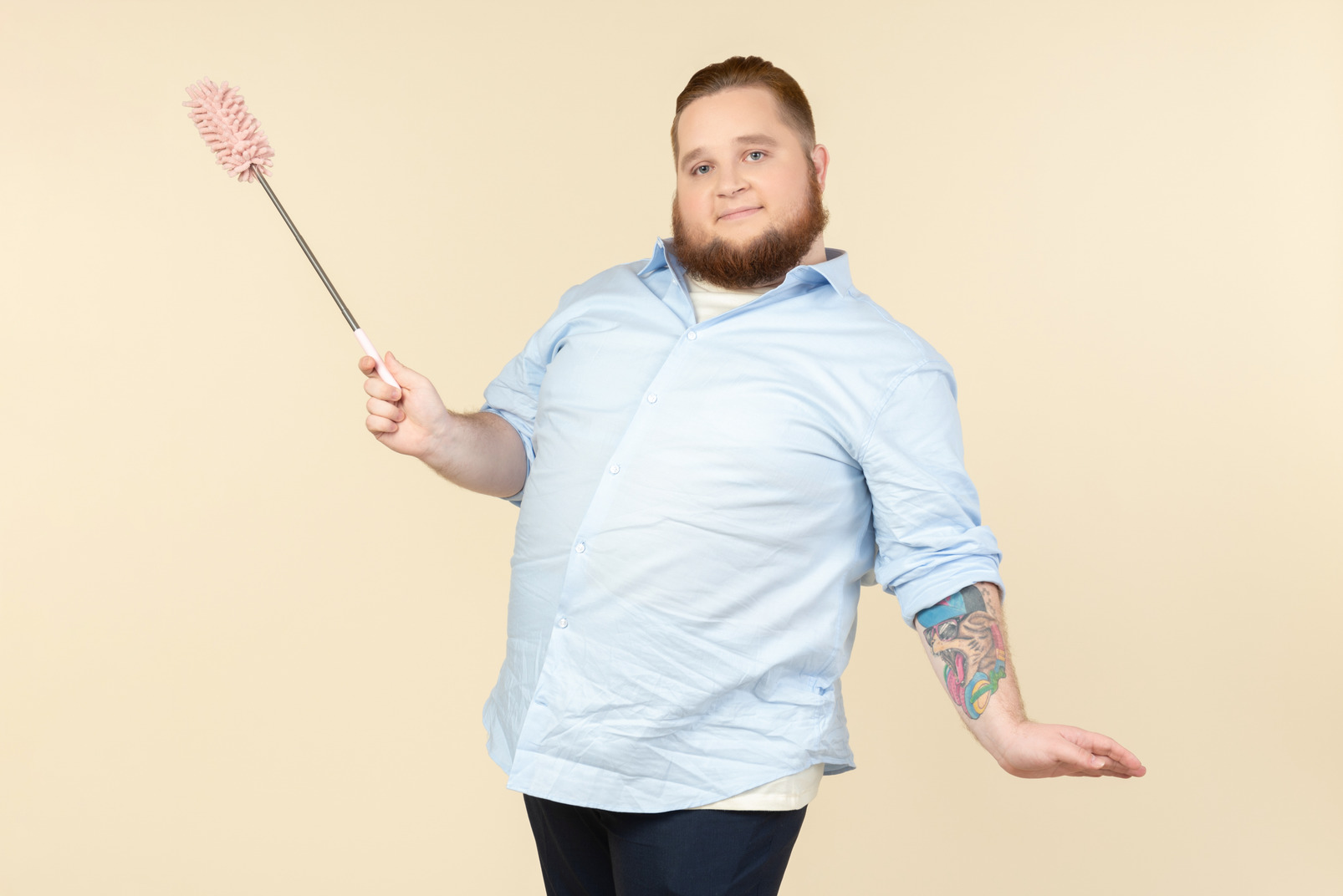 Young overweight househusband holding pipe cleaner