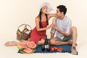 Young interracial couple having picnic