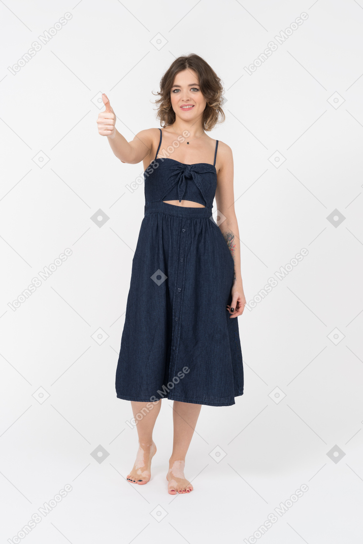 Pretty young woman showing a thumb up