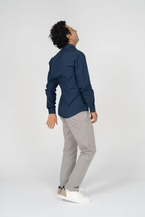 Side view of a man in casual clothes looking up