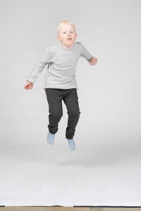 Front view of a boy jumping high