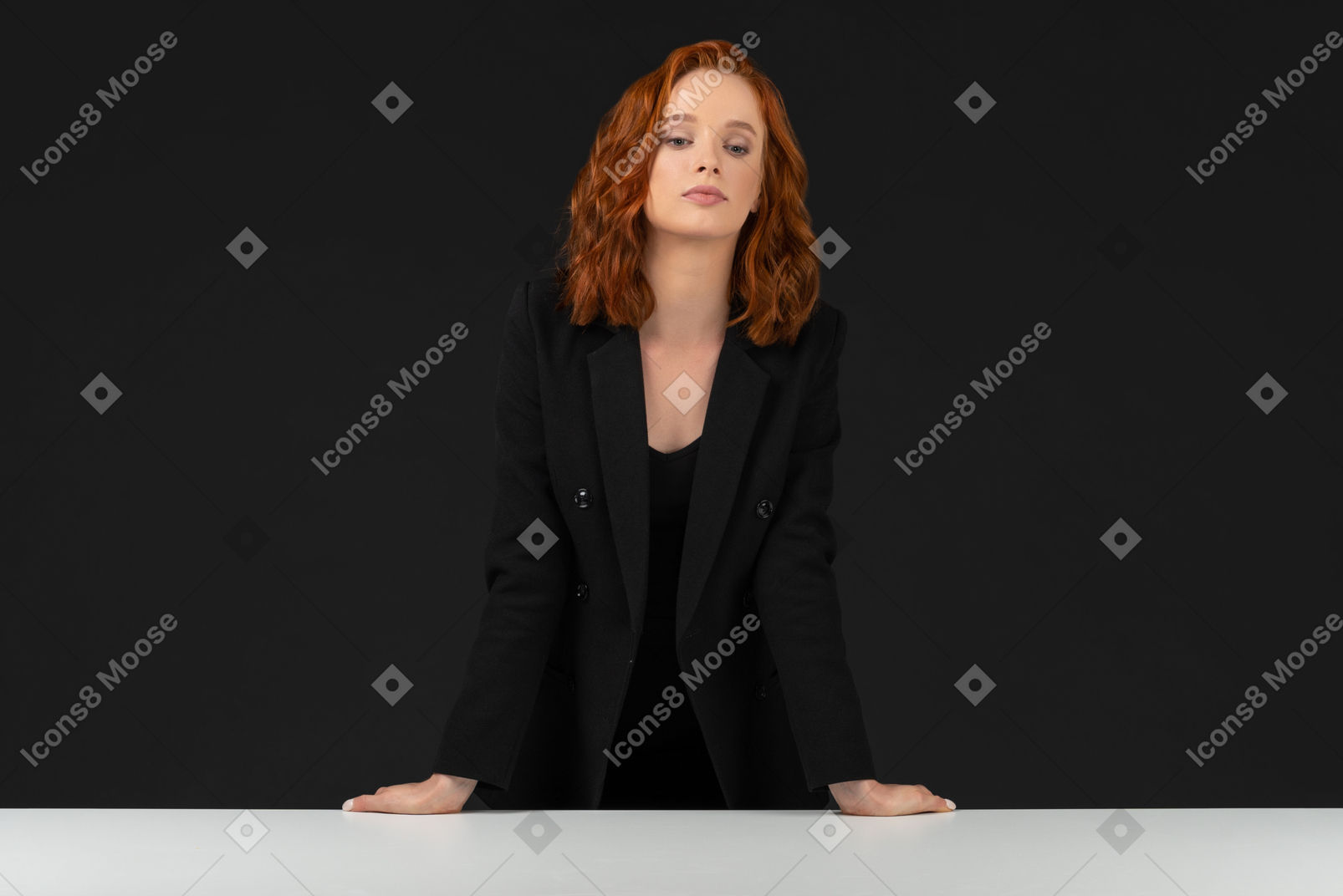 A frontal view of the cute woman dressed in black and looking at the camera