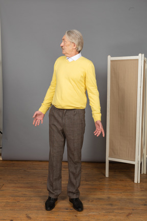 Front view of a questioning old man turning around