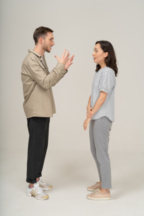 Side view of young couple speaking to each other