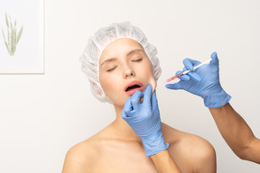 Young woman having her face injected with botox