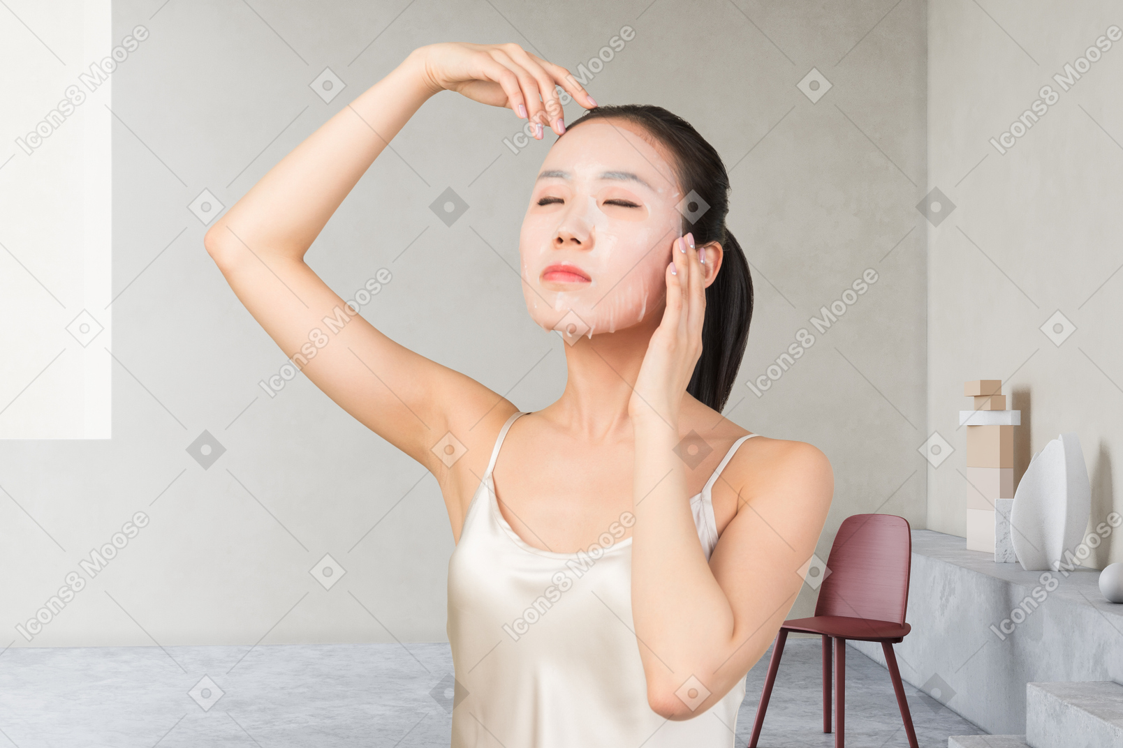 A woman in a white tank top applying a face mask