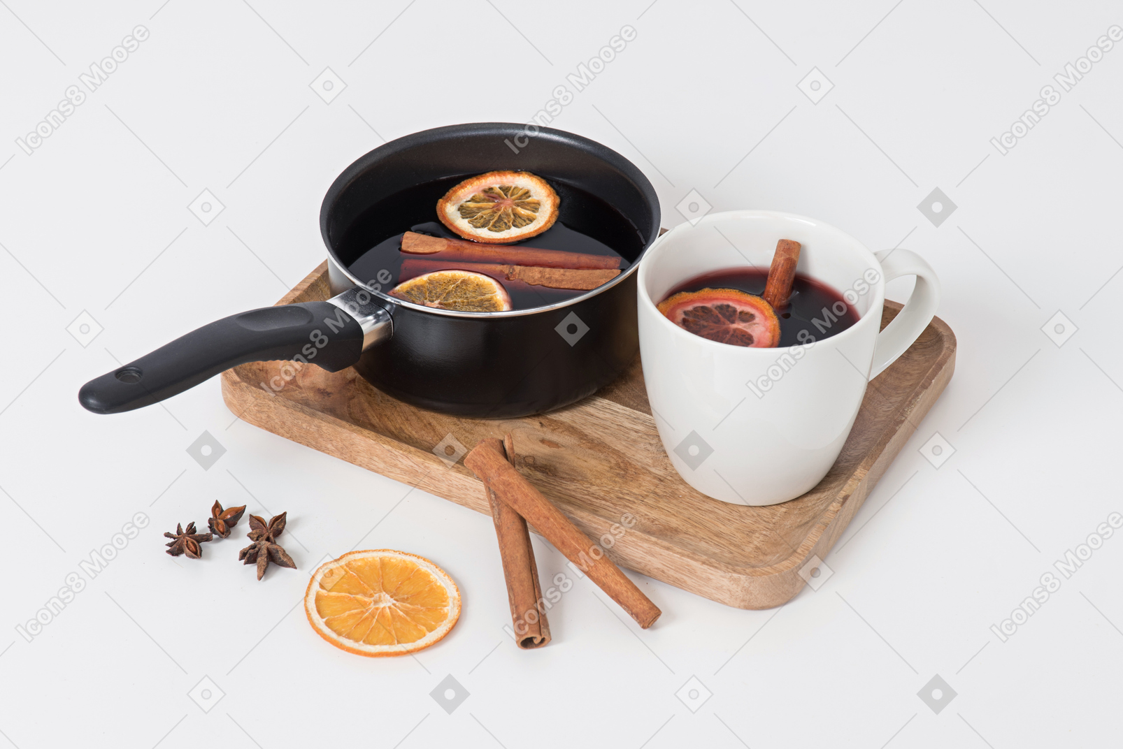 Mulled wine in pan and cup with christmas decorations near it