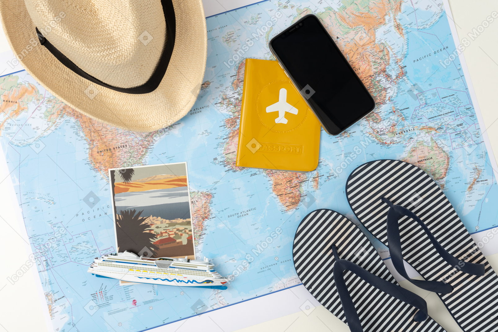 A passport, tiny ship model, flip-flops and a straw hat, all laid out beautifully over the world map, because i'm not just a tourist, but a designer