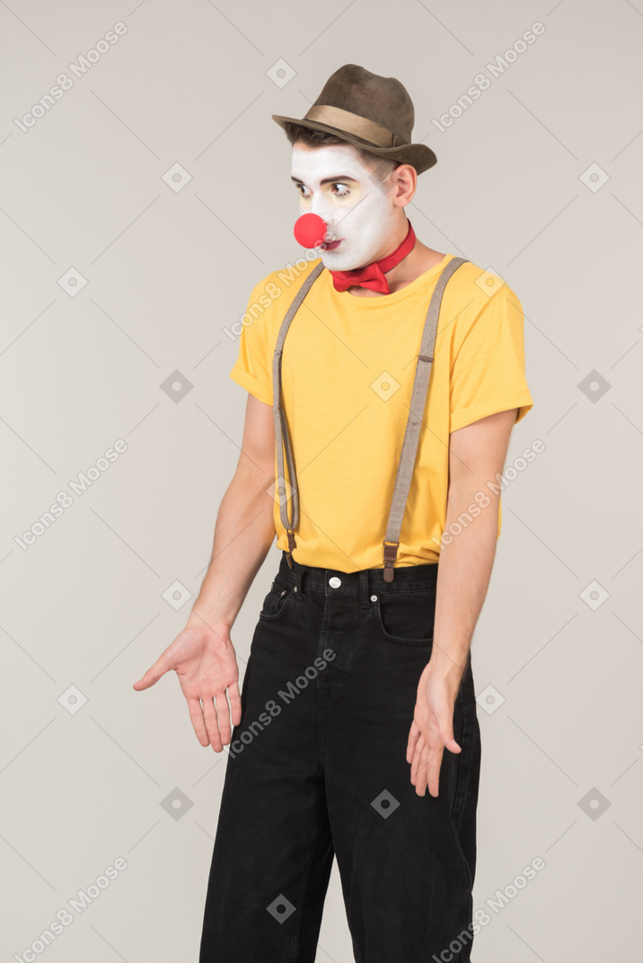 Male clown pointing at something his does