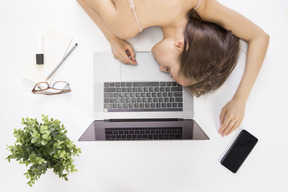 Young beautiful  woman sleeping on laptop
