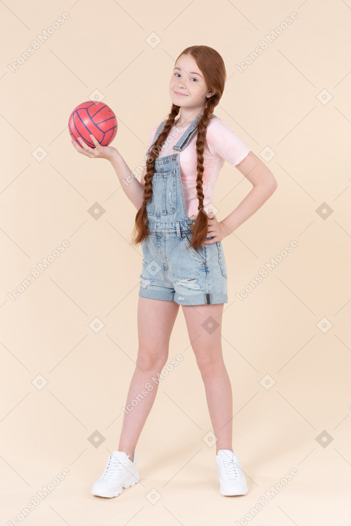 Teenage girl holding ball
