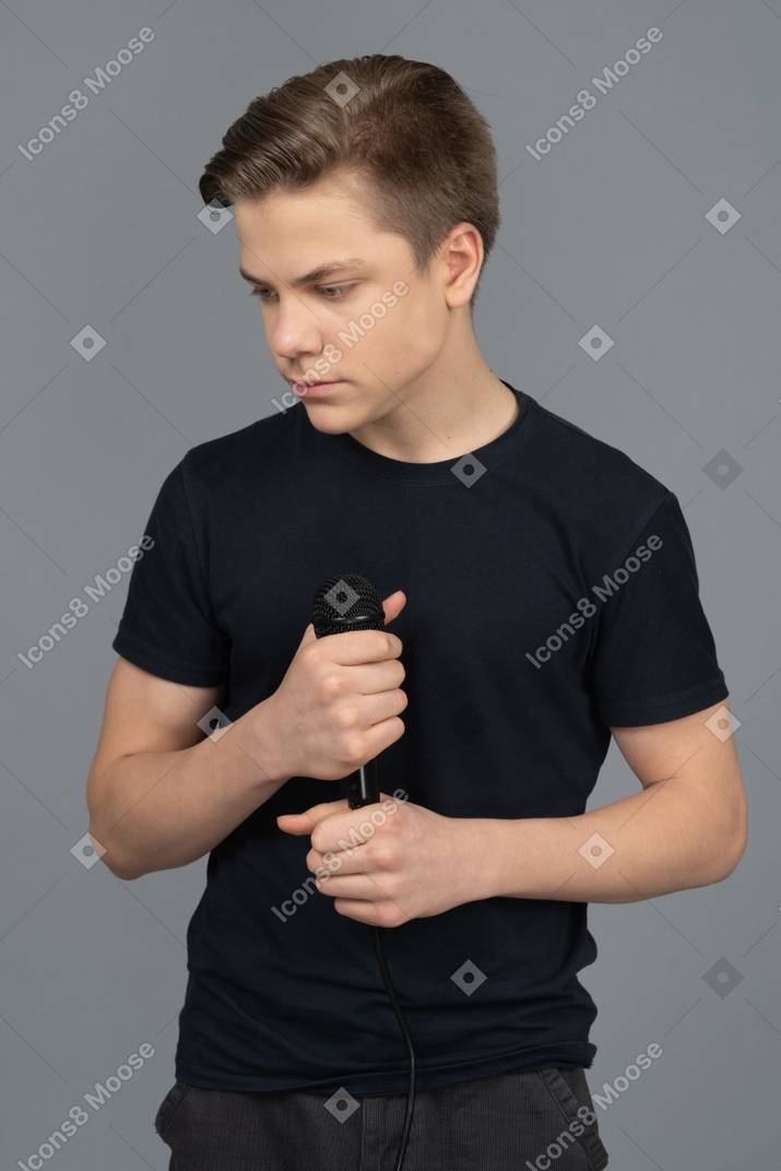 Sad young man holding a microphone