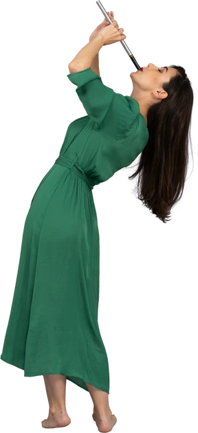Side view of a young lady in green dress playing flute while leaning back