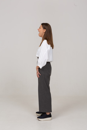 Side view of a yawning young lady in office clothing