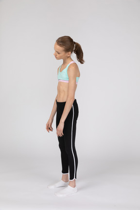 Three-quarter view of a tired teen girl in sportswear tilting her head