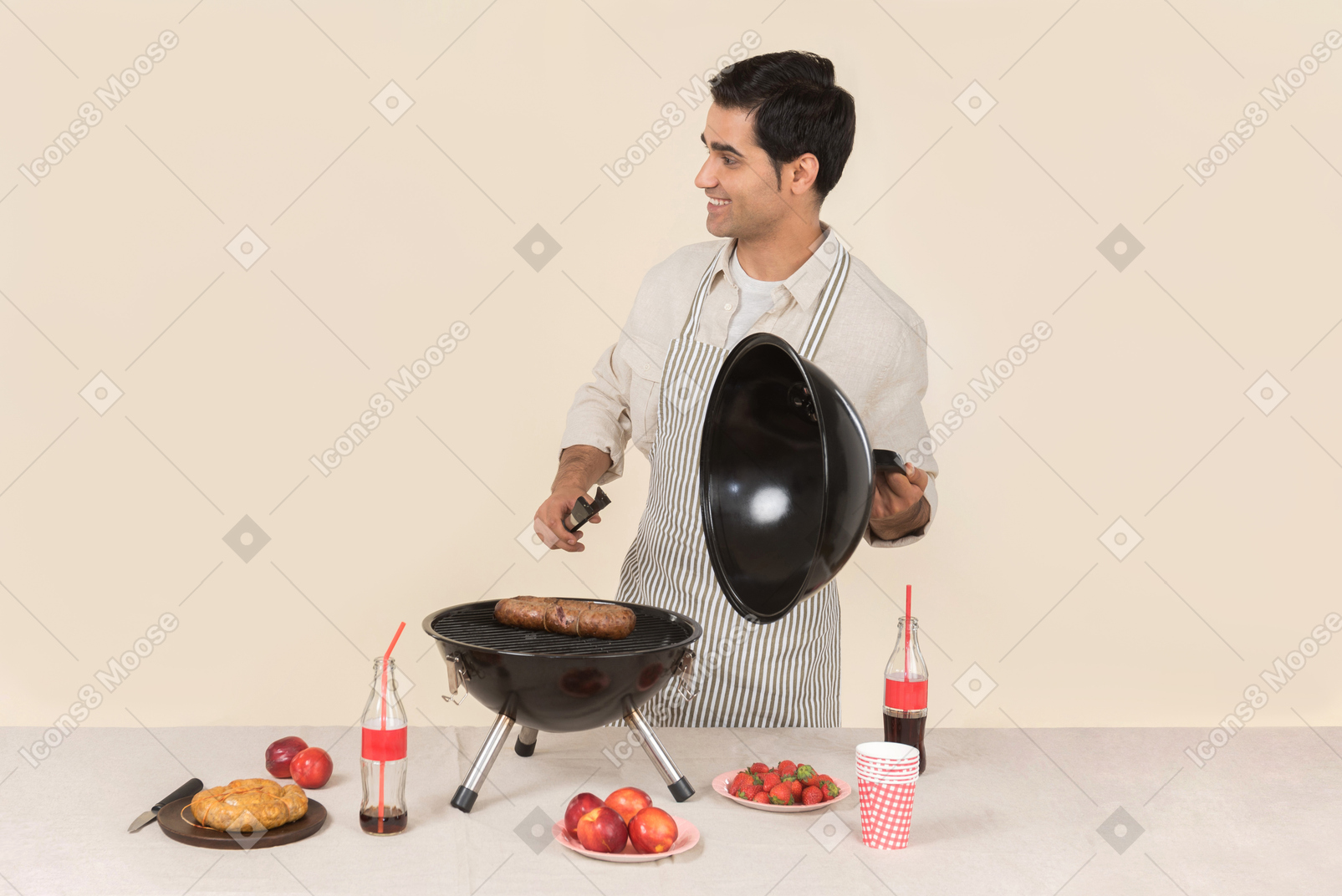 Smiling young caucasian man cooking bbq
