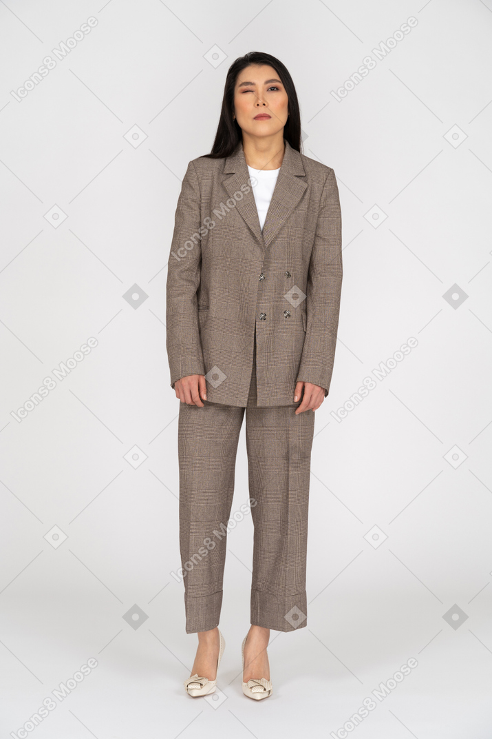 Front view of a winking young lady in brown business suit
