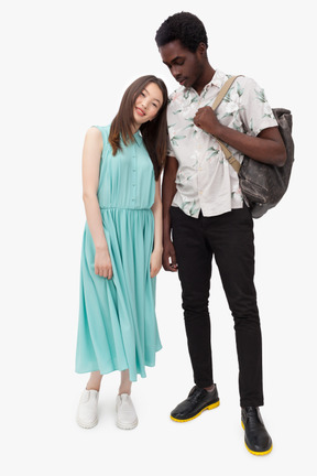 Asian woman leaning on her afro partner shoulder