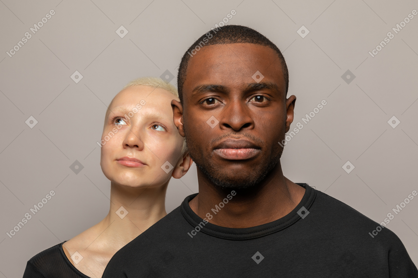 Young woman behind man looking up