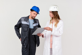 Female and male engineer colleagues discussing some work stuff