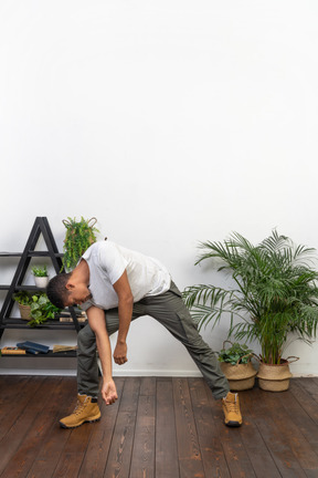 Handsome athletic man posing on the background of the apartment