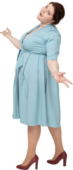 Side view of a woman in blue dress showing v signs