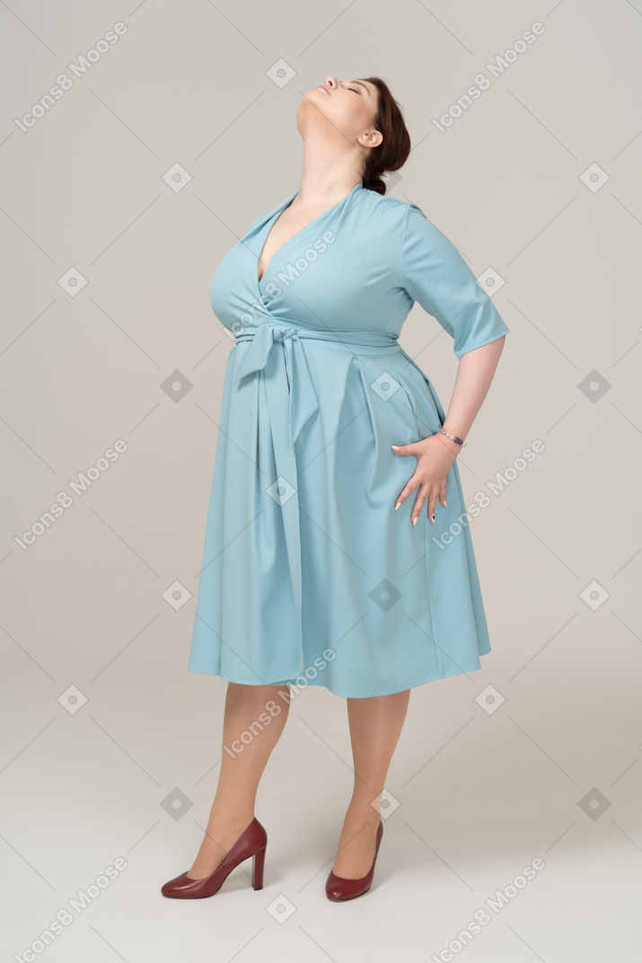 一个穿着蓝色裙子摆姿势的女人的前视图