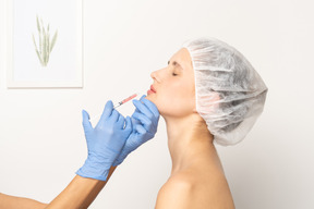 Side view of a woman getting botox injection