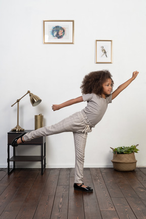 Good looking girl kid posing on the apartment background