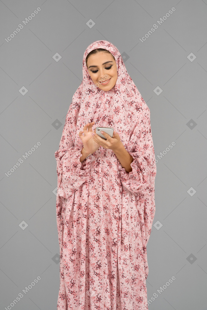 Cheerful arab woman with a mobile phone
