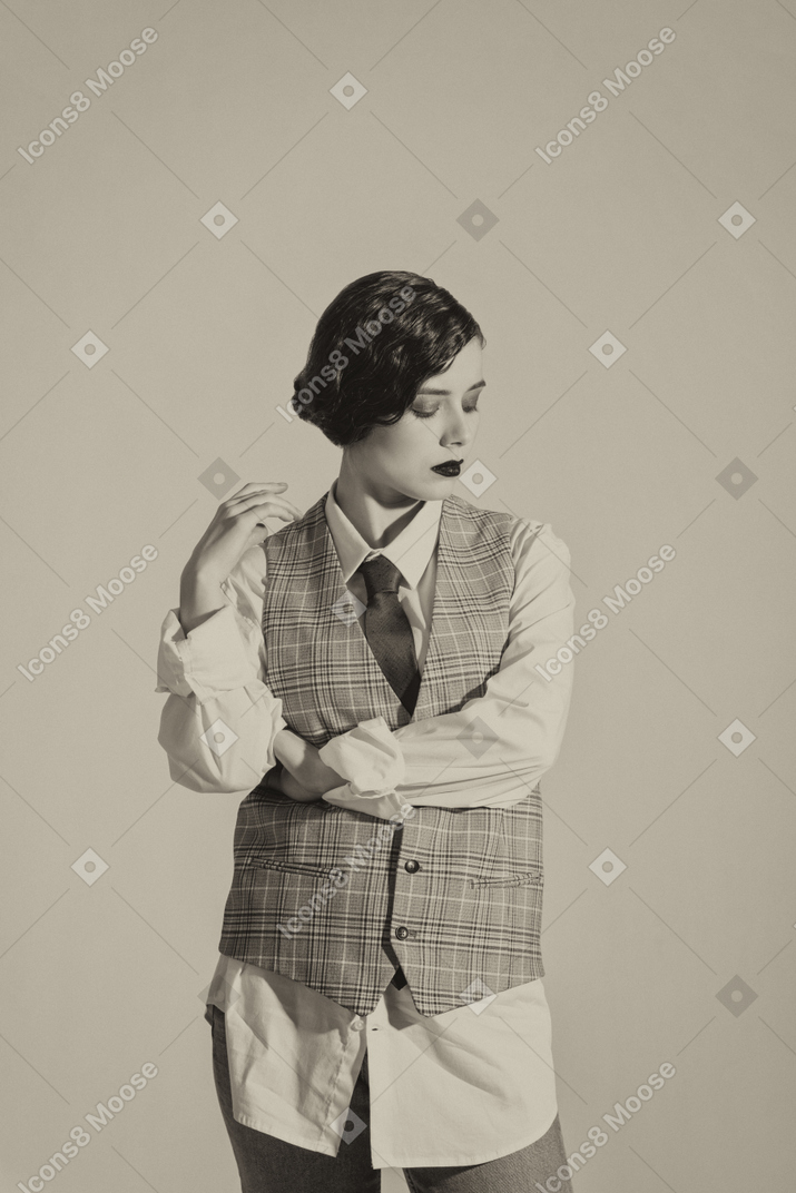 체크 무늬 조끼에 포즈를 취하는 아름 다운 복고풍 스타일의 여자