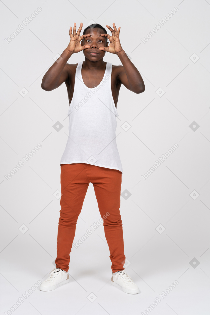 Man in tank top holding his eyes open