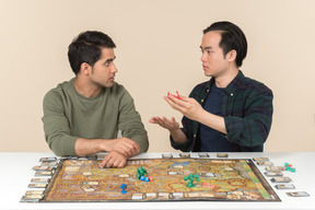 Amigos interraciales descubriendo algo mientras juegan juegos de mesa