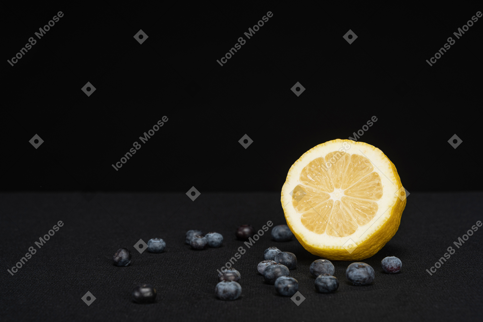 Lemon lying in black background with blueberries