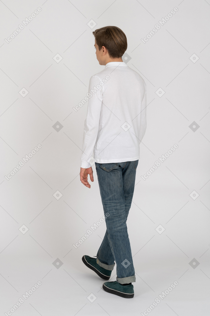 Young man in casual clothes walking