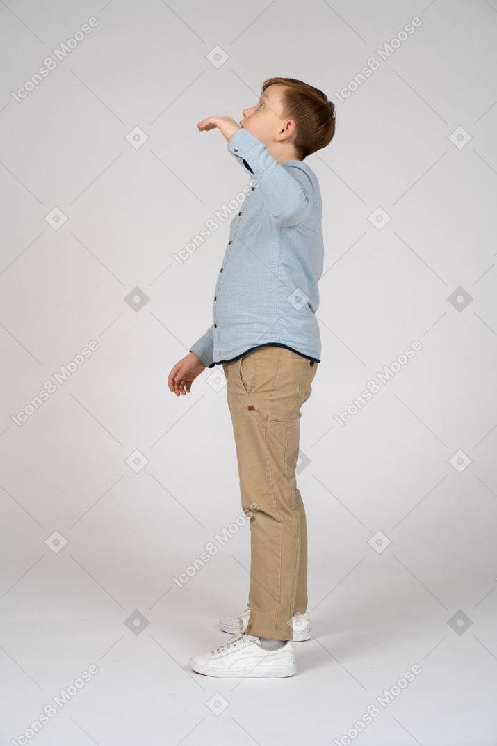 A little boy standing in a white room