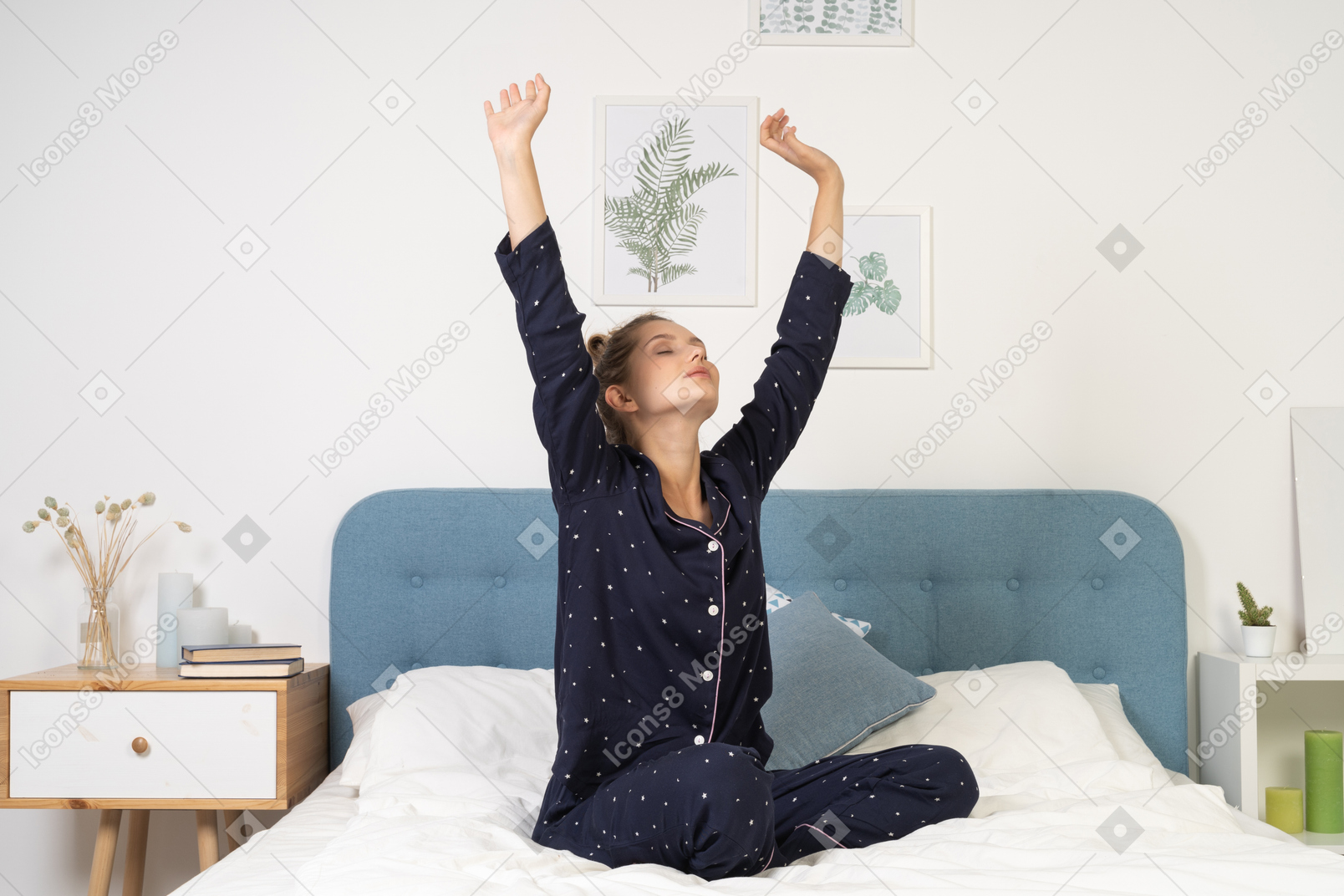 Front view of a stretching young lady in pajamas staying in bed