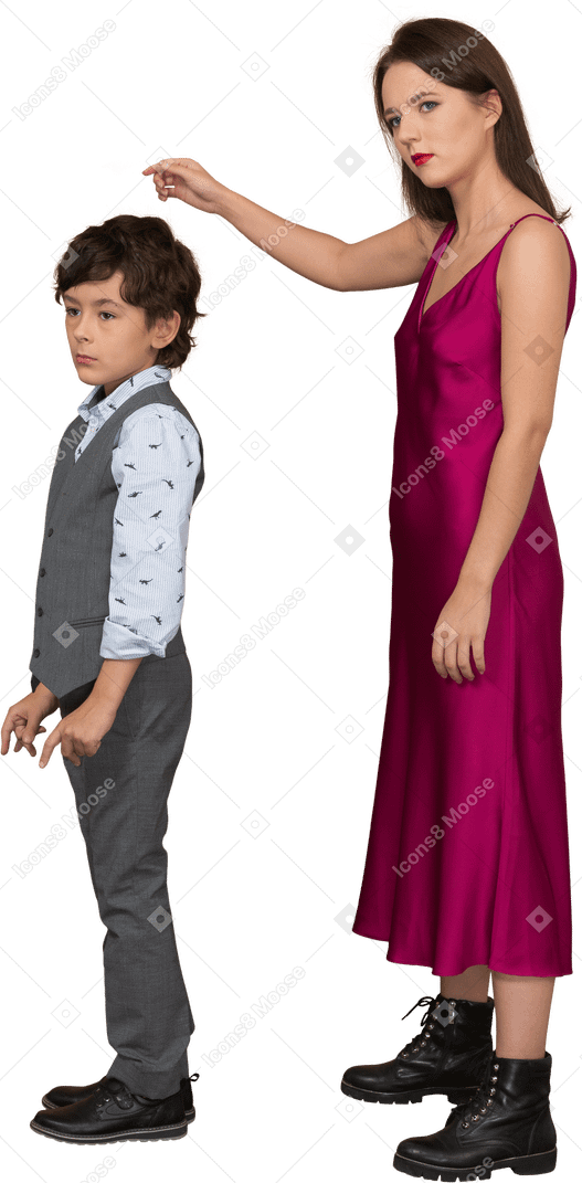 Young woman in red dress and boy standing still