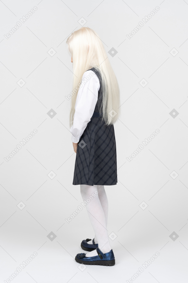 Side view of a schoolgirl with her head down