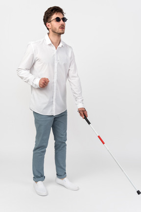 Blind man using a white cane