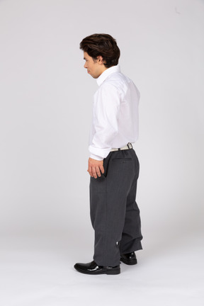 Three-quarter back view of a young office worker looking away
