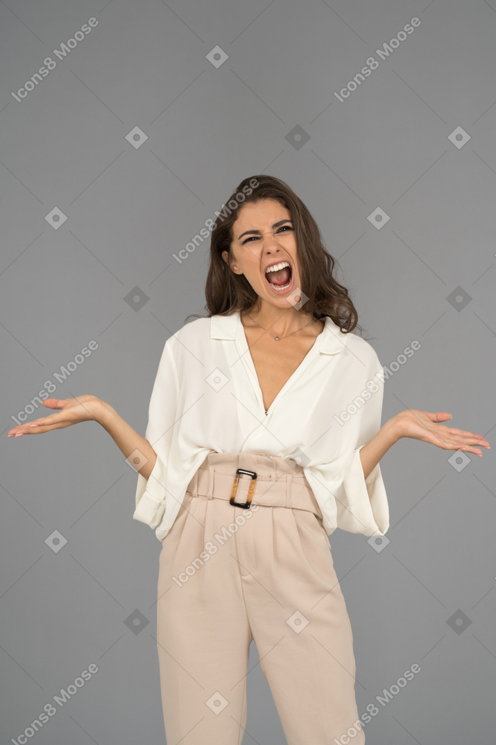 Depressed young woman screaming and gesturing